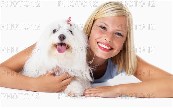 Studio Shot, Portrait of smiling young woman with her dog