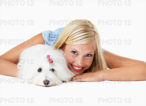 Studio Shot, Portrait of young woman lying down with het dog