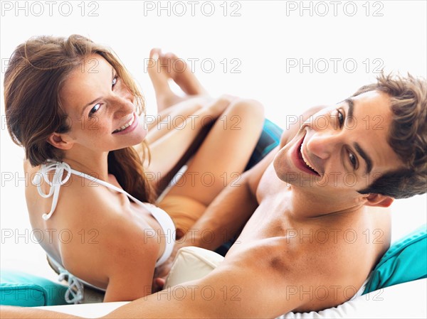 Couple relaxing on sofa together