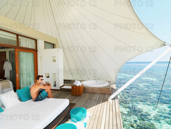 Man sitting on deck relaxing