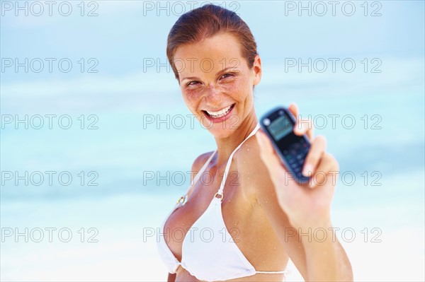 Portrait of young woman holding mobile phone