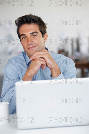 Portrait of man with laptop