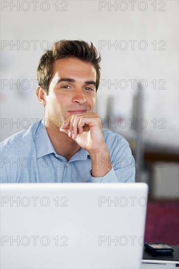 Portrait of man with laptop