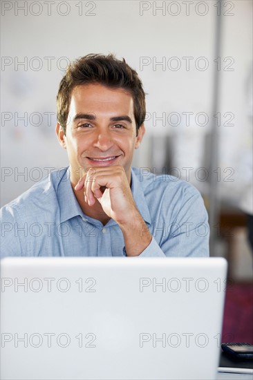 Portrait of man with laptop