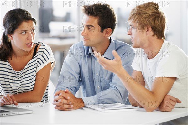 Coworkers discussing at table
