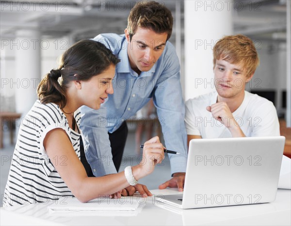 Coworkers looking at laptop