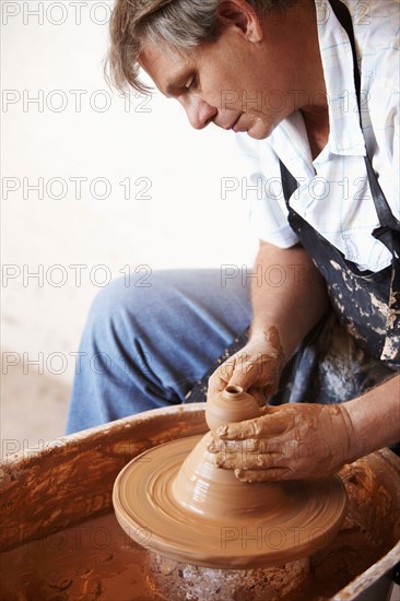 Potter concentrating on his work