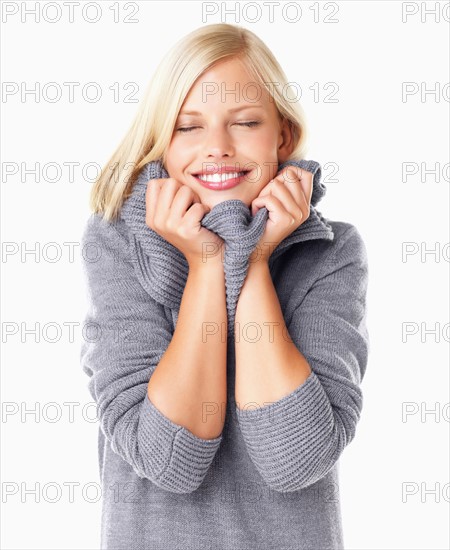 Studio portrait of young woman wearing gray sweater
