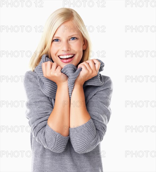 Studio portrait of young woman wearing gray sweater