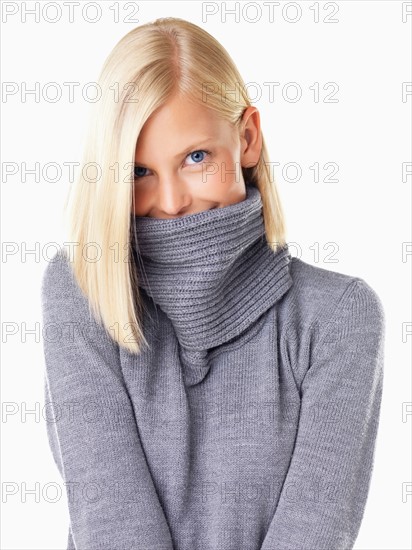 Studio portrait of young woman wearing gray sweater