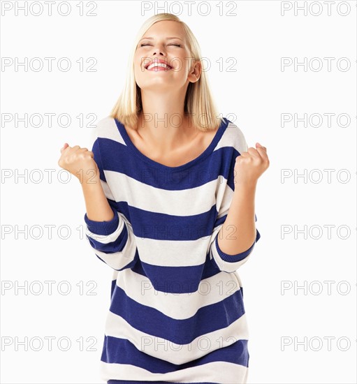 Studio portrait of young woman clenching fists