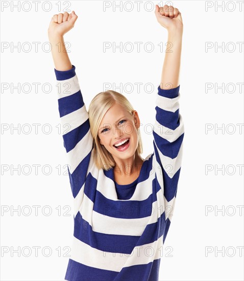 Studio portrait of young woman cheering