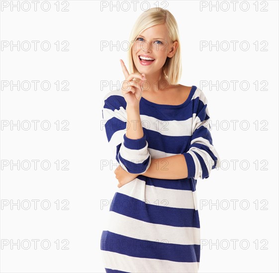 Studio portrait of young woman wagging finger