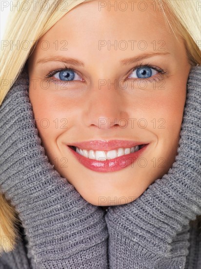 Studio portrait of young woman wearing gray sweater