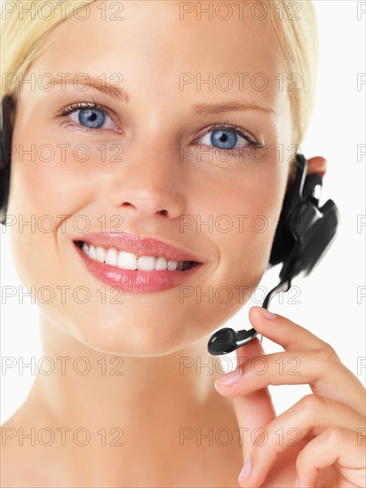 Studio portrait of young woman wearing headset