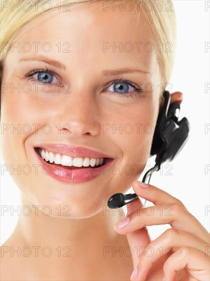 Studio portrait of young woman wearing headset