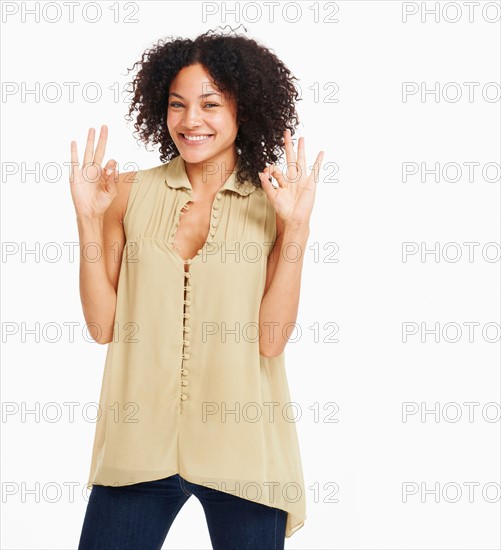 Studio portrait of young woman gesturing