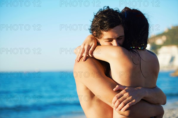 Young couple hugging at beach