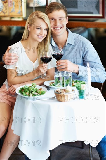 Couple drinking wine in restaurant