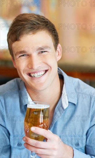 Portrait of man holding glass of beer