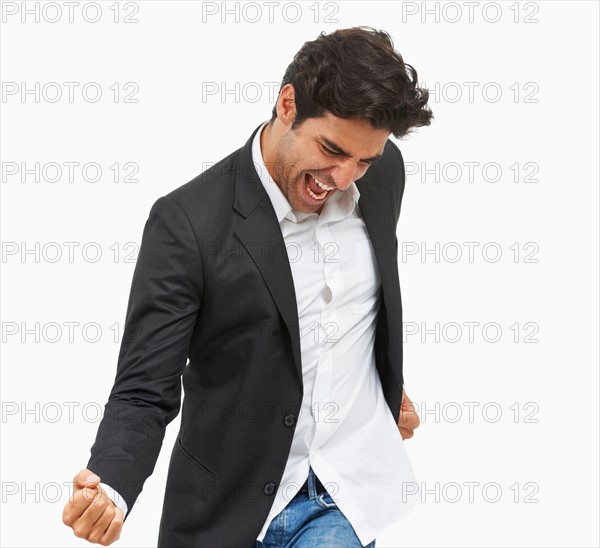 Studio portrait of stylish man cheering