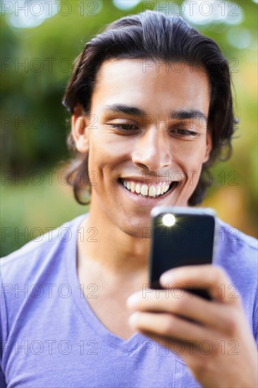 Portrait of young man using mobile phone