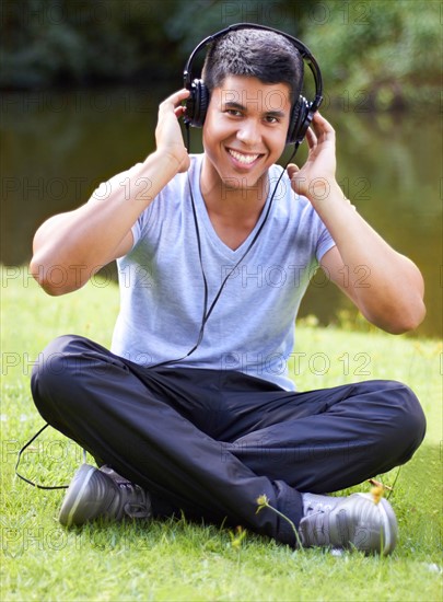 Portrait of young man listening to music with headphones