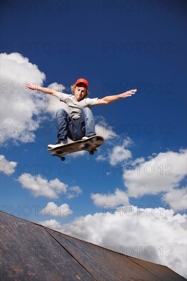 Young man on skateboard jumping