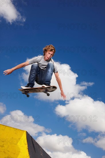 Young man on skateboard jumping