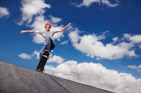 Young man on skateboard jumping