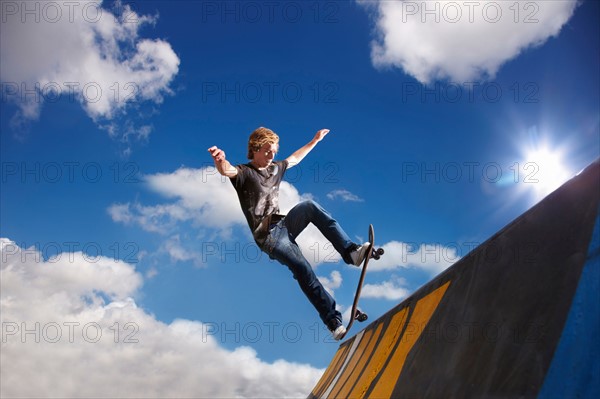 Young man on skateboard jumping