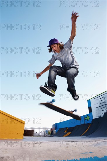 Young man on skateboard jumping