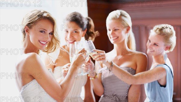 Bride and bridesmaids toasting