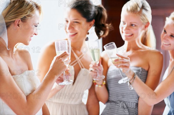 Bride and bridesmaids toasting