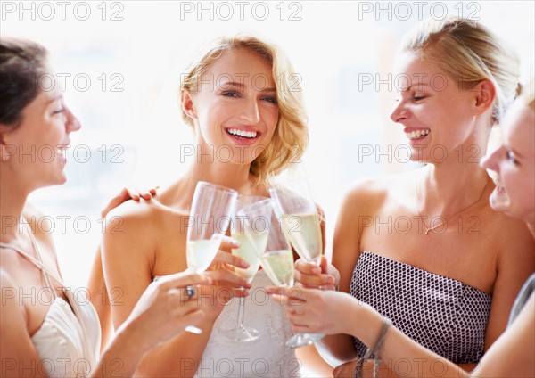 Bride and bridesmaids toasting