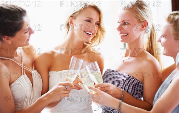 Bride and bridesmaids toasting