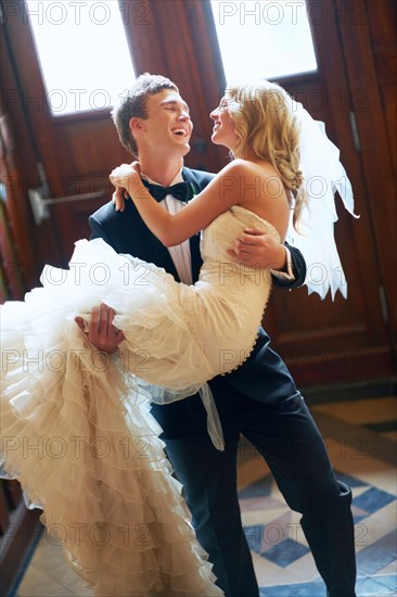 Groom carrying bride