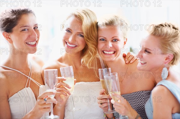 Bride and bridesmaids toasting