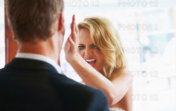 Bride slapping groom