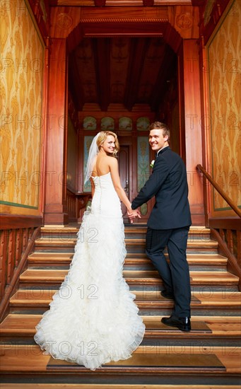 Young couple standing on steps in hallway