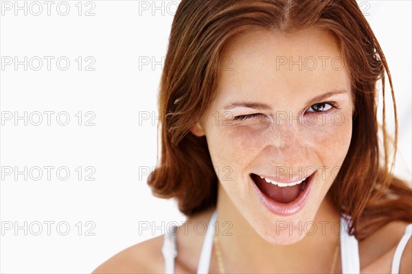 Studio portrait of winking  woman