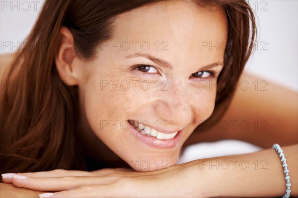 Studio portrait of woman smiling