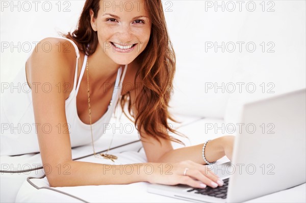 Studio portrait of woman using laptop