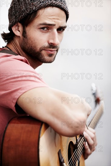 Portrait of musician playing guitar outdoors
