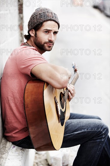 Portrait of musician playing guitar outdoors