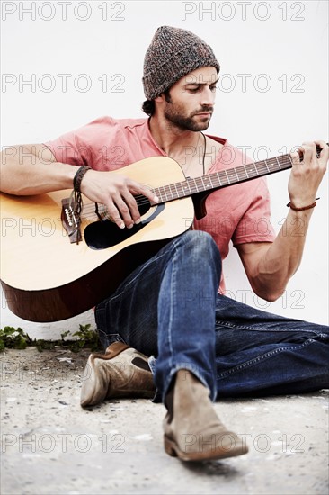 Musician playing guitar outdoors