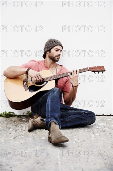 Musician playing guitar outdoors