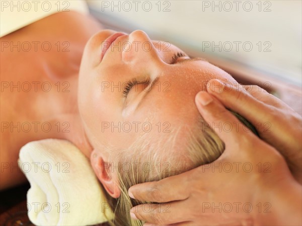 Mid adult woman receiving head massage