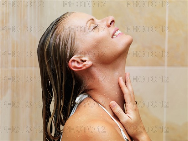 Mid adult woman in spa shower