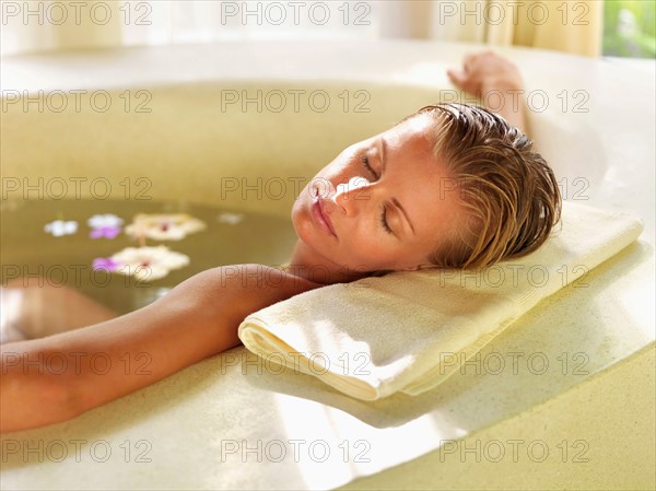 Woman relaxing in bathtub